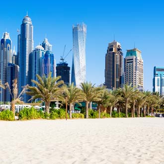 Strand van Dubai met hoge wolkenkrabbers en blauwe lucht