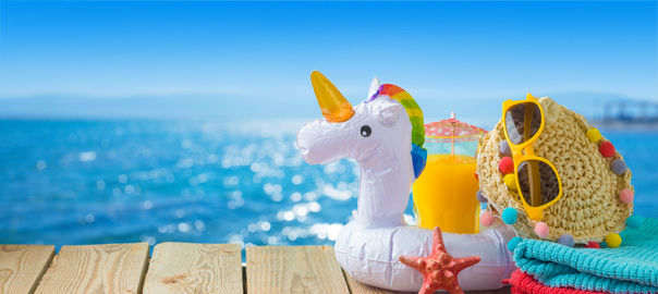 Opblaasbare unicorn met strandspullen en de zee